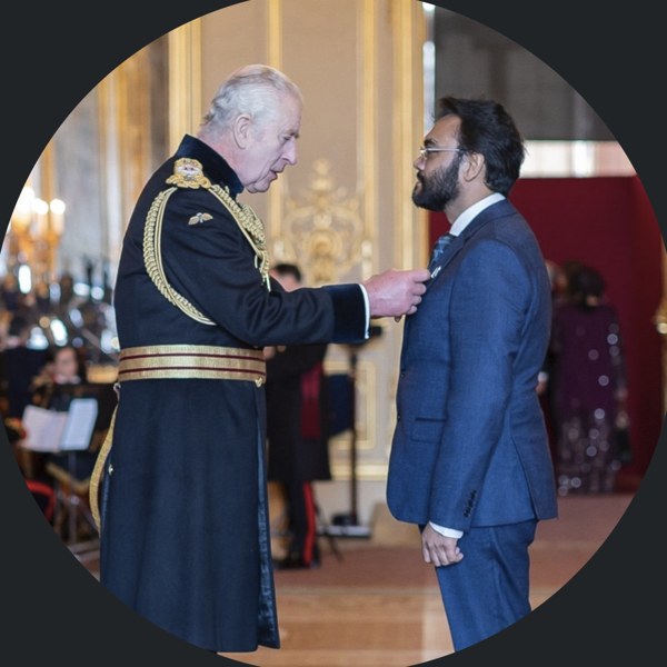 Prof. Dr Naseem Naqvi MBE receiving his MBE